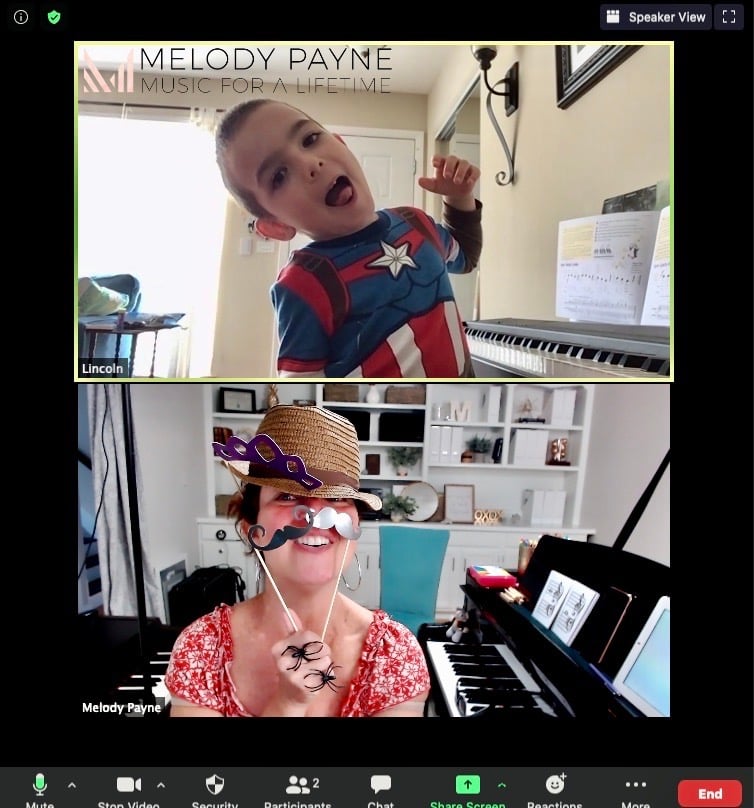 Young online piano student playing dress up the teacher